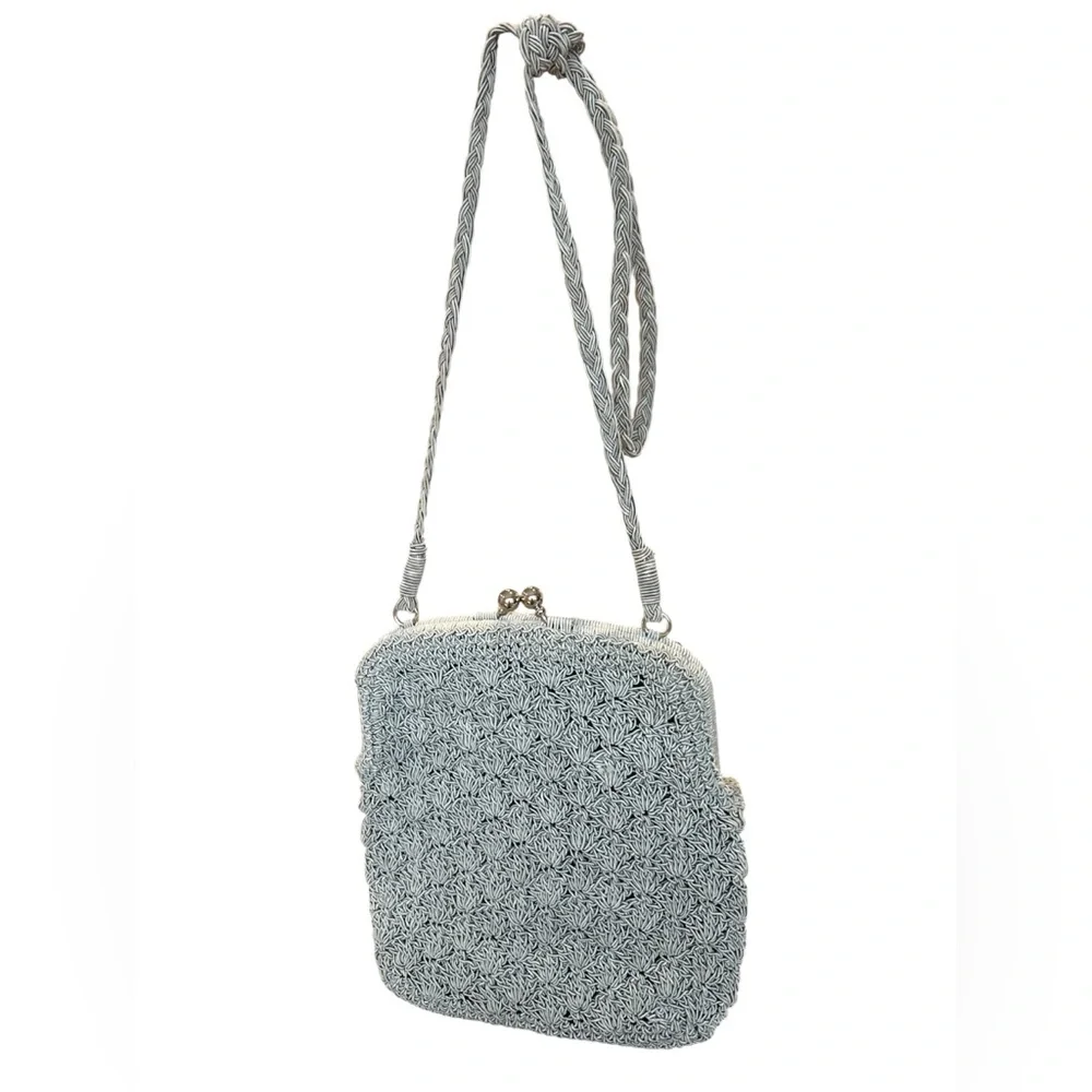 crocheted evening bag with a metal kiss-lock closure and braided shoulder strap